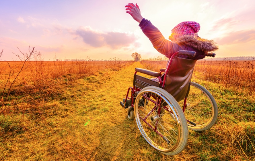 Woman in wheel chair looking at sunset