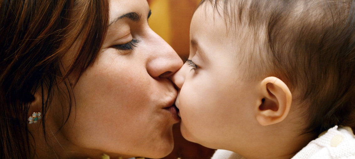 white mother and baby kissing